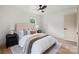 Bright main bedroom features a ceiling fan, hardwood floors, and an abundance of natural light at 3937 Tamerlane Dr, Charlotte, NC 28205