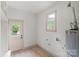 Bright utility room with a window, door to the outside, and a water heater at 3937 Tamerlane Dr, Charlotte, NC 28205