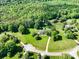 Aerial view of the property showcasing the home, surrounding greenery, and serene setting at 4628 Dovefield Ln, Kannapolis, NC 28081