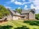 View of the rear of the home highlighting the siding, windows, and well-kept backyard at 4628 Dovefield Ln, Kannapolis, NC 28081