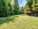 Expansive backyard, partially fenced, offers privacy and space for outdoor activities and recreation at 4628 Dovefield Ln, Kannapolis, NC 28081