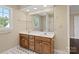 Bathroom features a double vanity, large mirror, and a shower-tub combination at 4628 Dovefield Ln, Kannapolis, NC 28081
