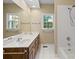 Bathroom featuring double sink vanity, tile floors, and tub/shower combination at 4628 Dovefield Ln, Kannapolis, NC 28081