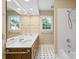 Bright bathroom featuring a double vanity, large mirror, shower-tub combination, and natural light at 4628 Dovefield Ln, Kannapolis, NC 28081
