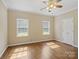 Bright bedroom with hardwood floors, closet, and natural light from two windows at 4628 Dovefield Ln, Kannapolis, NC 28081