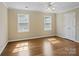Bedroom features hardwood floors, neutral paint, ceiling fan, and ample natural light at 4628 Dovefield Ln, Kannapolis, NC 28081