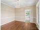 Spacious dining room featuring hardwood floors, and views to the back yard through a window at 4628 Dovefield Ln, Kannapolis, NC 28081