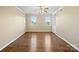 Spacious living room featuring hardwood floors, natural light, a ceiling fan, and built-in shelving at 4628 Dovefield Ln, Kannapolis, NC 28081
