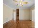 Open living room with hardwood floors, built-in shelving, and ample natural light at 4628 Dovefield Ln, Kannapolis, NC 28081