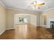 Spacious living room featuring hardwood floors, elegant archways, and a cozy fireplace at 4628 Dovefield Ln, Kannapolis, NC 28081
