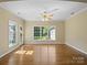 Bright sunroom featuring hardwood floors, large windows, and access to the outdoors at 4628 Dovefield Ln, Kannapolis, NC 28081