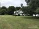 Charming home with meticulously maintained lawn, complemented by lush greenery and mature trees in a serene setting at 609 E Church St, China Grove, NC 28023