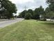 Desirable corner lot property featuring a well-maintained lawn, mature trees, and attractive street appeal at 609 E Church St, China Grove, NC 28023
