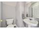 Powder room featuring pedestal sink, a mirror, and neutral paint at 6335 Ziegler Ln, Charlotte, NC 28269
