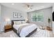 Bedroom featuring a king-size bed with soft linens, ceiling fan, and natural light at 6335 Ziegler Ln, Charlotte, NC 28269
