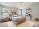Bedroom with a wooden bed, a ceiling fan, lots of light, and carpeted floors at 6335 Ziegler Ln, Charlotte, NC 28269