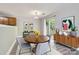 Cozy dining room featuring a round table, modern decor, and access to the backyard, perfect for Gathering meals at 6335 Ziegler Ln, Charlotte, NC 28269