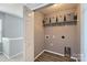 Upstairs laundry room with shelf, basket storage and wood-look vinyl floors at 6335 Ziegler Ln, Charlotte, NC 28269