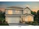 Charming two-story home with attached garage, manicured lawn, and landscaped yard at 7065 Stella Pl, Stanley, NC 28164
