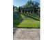 Landscaped backyard with healthy lawn, fence, and arborvitae trees providing shade at 745 Garrett Green Way, Fort Mill, SC 29715