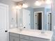 Bathroom featuring dual sinks, bright white countertop, and large mirror, enhanced by modern chrome fixtures at 745 Garrett Green Way, Fort Mill, SC 29715