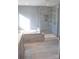 Bathroom showcasing a glass-enclosed shower, a soaking tub, and tiled flooring at 745 Garrett Green Way, Fort Mill, SC 29715