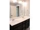 Bathroom vanity featuring dual sinks, dark cabinetry, white countertop, modern chrome faucets, and large mirror at 745 Garrett Green Way, Fort Mill, SC 29715