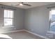 Bright bedroom with neutral walls, carpet, and dual windows, enhanced by a modern ceiling fan with light fixture at 745 Garrett Green Way, Fort Mill, SC 29715