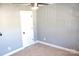Bedroom with neutral walls, carpet, and white door, complemented by a modern ceiling fan with light fixture at 745 Garrett Green Way, Fort Mill, SC 29715