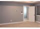 Bright bedroom with neutral walls, carpet, and an open doorway, illuminated by natural light from the window at 745 Garrett Green Way, Fort Mill, SC 29715