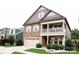 Inviting exterior with stone accents, covered porch, two car garage, and well-maintained lawn at 745 Garrett Green Way, Fort Mill, SC 29715