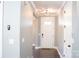 Well-lit hallway with stylish light fixture and sleek gray walls leading to front door and closet at 745 Garrett Green Way, Fort Mill, SC 29715