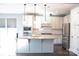 Modern kitchen featuring stainless steel appliances, marble backsplash, and a large kitchen island at 745 Garrett Green Way, Fort Mill, SC 29715
