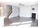 Spacious living room with dark wood flooring, fireplace, and large window for natural light at 745 Garrett Green Way, Fort Mill, SC 29715