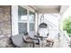 Relaxing porch area featuring a hanging swing chair and comfortable seating, perfect for outdoor lounging at 745 Garrett Green Way, Fort Mill, SC 29715