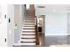 Elegant staircase with hardwood steps and a classic railing design leading to the upper level at 745 Garrett Green Way, Fort Mill, SC 29715