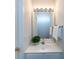 Compact half-bathroom featuring a vanity with a sink, a mirror, and simple decor at 8040 Flanders St, Charlotte, NC 28277