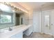 A spacious bathroom with double sinks, large mirror, bathtub and natural light at 8040 Flanders St, Charlotte, NC 28277