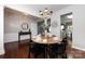 Cozy dining room with wood floors, round table, and view to foyer and open kitchen at 8040 Flanders St, Charlotte, NC 28277