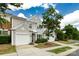 Beautiful townhome with attached garage, green lawn and a lovely tree in the front yard at 8040 Flanders St, Charlotte, NC 28277