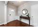Warm and inviting foyer with hardwood floors, elegant wainscoting, and a stylish console table at 8040 Flanders St, Charlotte, NC 28277
