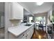 Modern kitchen with white countertops and view to the dining area and fireplace in the living room at 8040 Flanders St, Charlotte, NC 28277