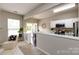 Open kitchen with white cabinets, stainless steel appliances, and adjacent dining area with outdoor access at 8040 Flanders St, Charlotte, NC 28277