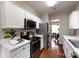 Contemporary kitchen with stainless steel appliances, white cabinetry, and view into the dining area at 8040 Flanders St, Charlotte, NC 28277