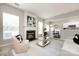 Inviting living room featuring a fireplace, large windows, and stylish decor at 8040 Flanders St, Charlotte, NC 28277