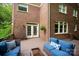 Cozy outdoor seating on a covered patio with brick accents makes a charming area to relax at 8227 Lansford Rd, Charlotte, NC 28277