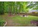 Expansive backyard showcasing a fire pit area, hammock, and lush landscaping for outdoor enjoyment at 8227 Lansford Rd, Charlotte, NC 28277