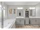 Bright bathroom featuring double sinks, storage and a garden tub at 8227 Lansford Rd, Charlotte, NC 28277