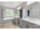 Spacious bathroom with double vanities and a soaking tub by the window at 8227 Lansford Rd, Charlotte, NC 28277