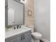 Half bathroom featuring modern vanity with a light wood accent wall at 8227 Lansford Rd, Charlotte, NC 28277